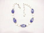 This is a vintage choker necklace signed JAPAN.  It has cobalt blue art glass beads with white swirls and solid white glass beads.  The necklace is adjustable and measures from 14 to 16 inches long.  ...