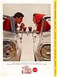 This ad was taken from the National Geographic Magazine, April 1965. It features Coca Cola at a drive-in restaurant scene.  This ad is in good condition considering its age.  