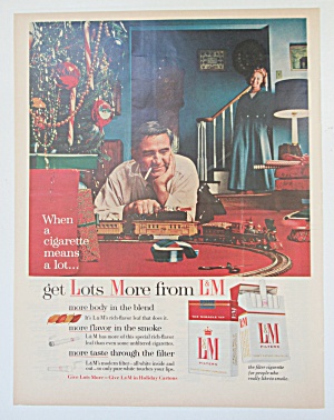 1955 L & M Cigarettes With Man Playing With Train