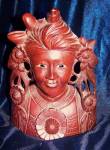 Rosewood mask carving of woman.