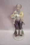 Porcelain Young Man With Basket Of Flowers Figurine