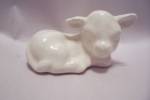 Cute small white porcelain lamb figurine.  Unsigned.  3" long.  Fine condition with no damage.  1980s.