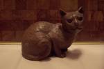 Very heavy composition brown cat figurine that looks like hand carved wood.  Unsigned.  6-1/2" long.  Very good condition with no damage.  Circa unknown.
