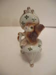 Cute vintage squirrel sitting on a parlor chair porcelain figurine with gilt trim.  Signed on the underside.  4-1/2" tall.  Fine condition with no damage.  1950-60s.  Can mail First Class Mail.