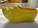 Vintage Nelson McCoy Dutch shoe pottery vase planter. c:1940's. Daisy like flower design on the top part of shoe. No chips or cracks but has some dark crazing; a small depression on top rim; a pinpop ...