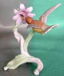 Beautiful West Germany figurine of a hummingbird getting nectar from a pink flower. 5" tall x 4 1/2" long.