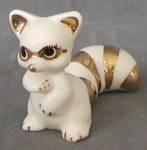 Darling 2 2/2" tall x 4" long china white  raccoon with metallic gold nose, mask, inside of ears, nails and tail stripes. Very good.