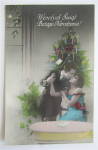 Man & Woman Kissing In Front Of Christmas Tree Postcard