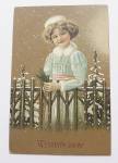 Click to view larger image of Girl In The Snow By A Fence Christmas Postcard  (Image1)