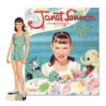 Janet Lennon Singing Star Cut-Out Doll Two-Fold Portfolia by the Lennon Sisters Productions contains a reproduction of the 1958 paper doll of Janet, the youngest sister; and 53 pieces of clothes and accessories to cut out. The portfolio of this set shows Janet's bedroom, dolls, and toys in the background with pouches to store the heavy board punch paper doll and her color paper clothes, which need to be cut out.  Produced in 2010 as a reproduction of the 1958 set. New and mint.