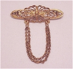 VINTAGE ANTIQUED GOLD TONE FILIGREE BROOCH WITH DANGLING CHAINS