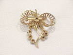 Click to view larger image of VINTAGE BLUE RHINESTONE GOLD TONE BOW BROOCH OR PENDANT (Image3)