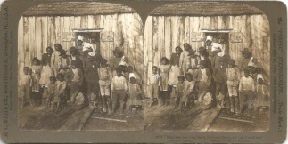 Stereo View, Negro Slaves Posing in Front of a Wooden Shack (Image1)